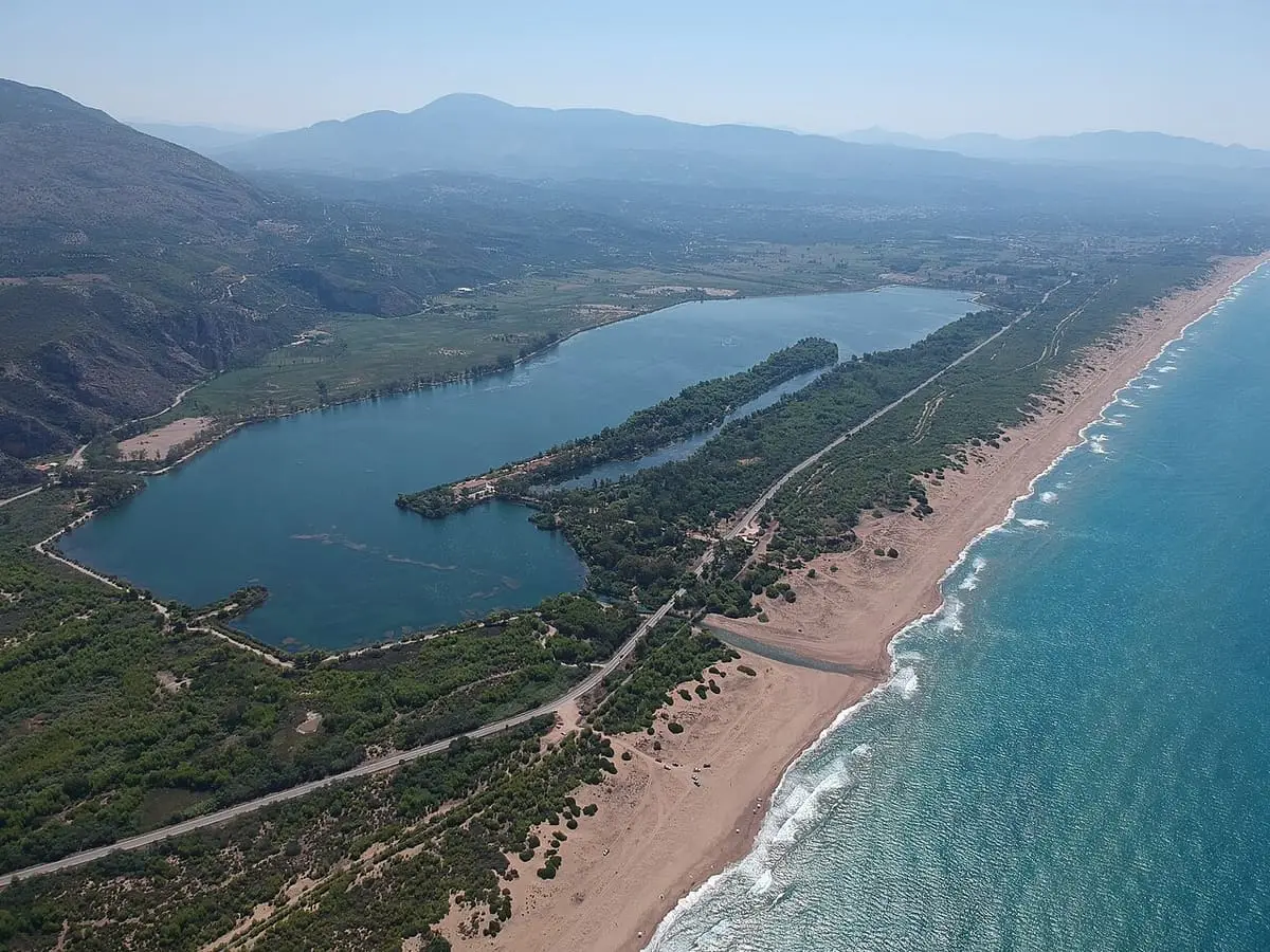 Aerial view of Lake Kaiafas, its wooded sandbar and the long beach beside the sea