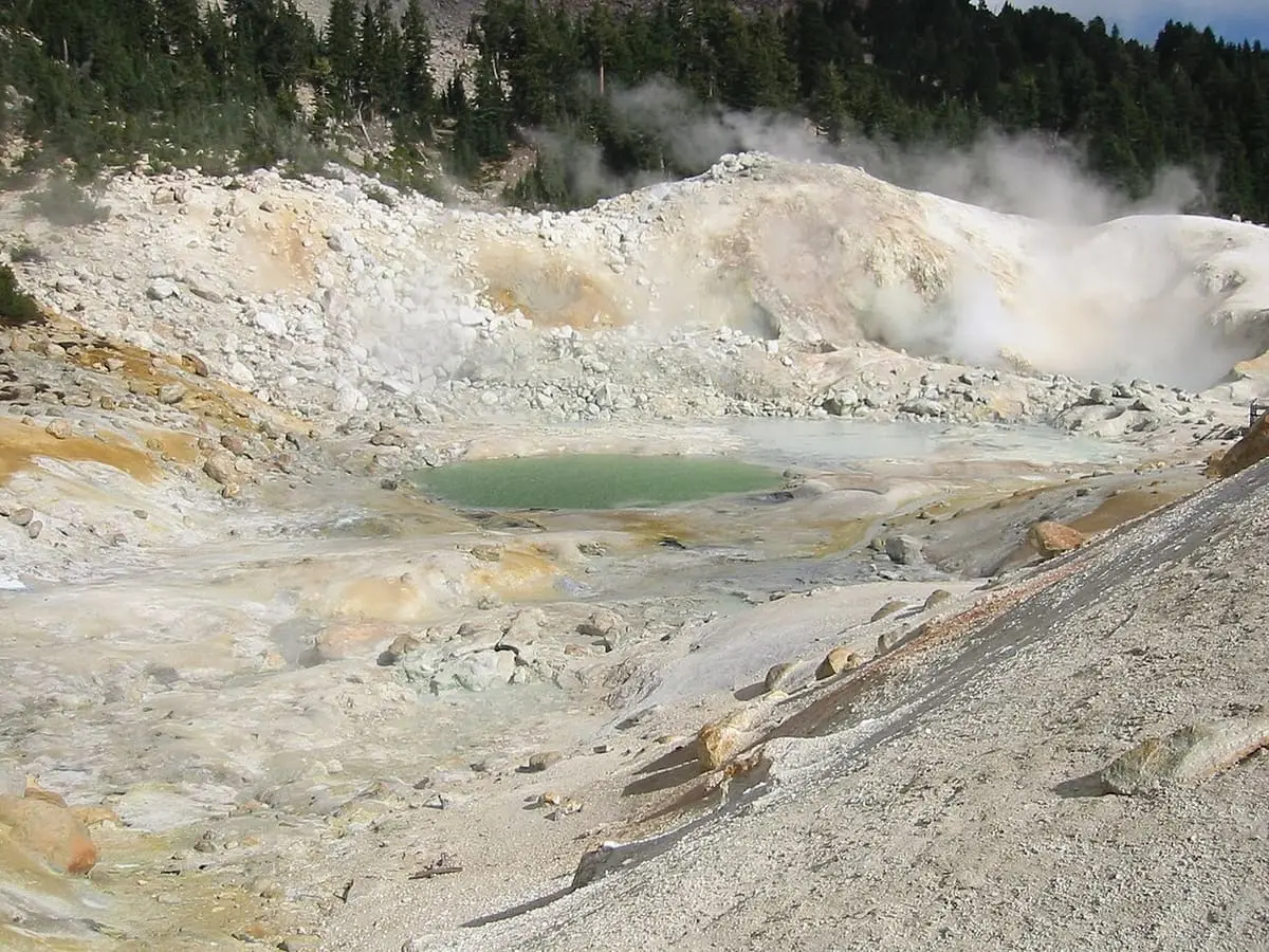 Milky green hot pool in the pale, steaming basin of Bumpass Hell in Lassen Volcanic National Park