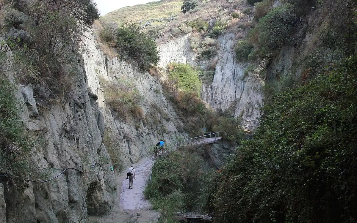 Narrow path through the steep tuff gorge leading to the Cavascura bathing grottoes