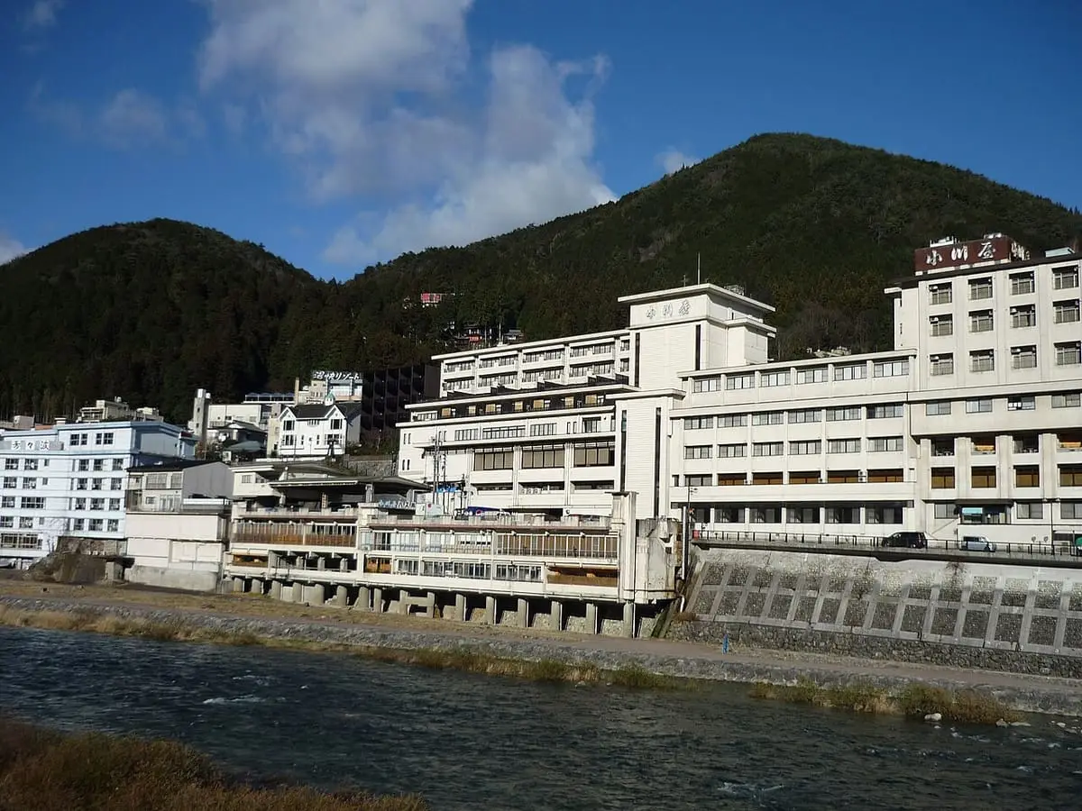 Large hot spring hotels of Gero Onsen beside the Hida River under a blue sky