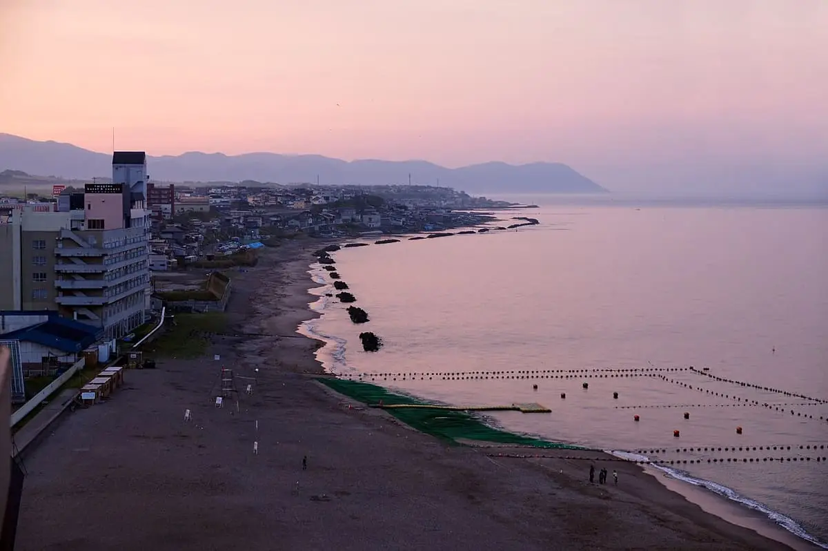 Beach and hotels of Yunokawa Onsen along the Tsugaru Strait at dusk