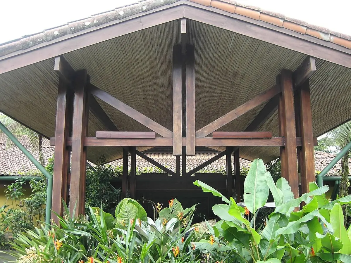 Open wooden pavilion roof above tropical plants at Tabacón Thermal Resort