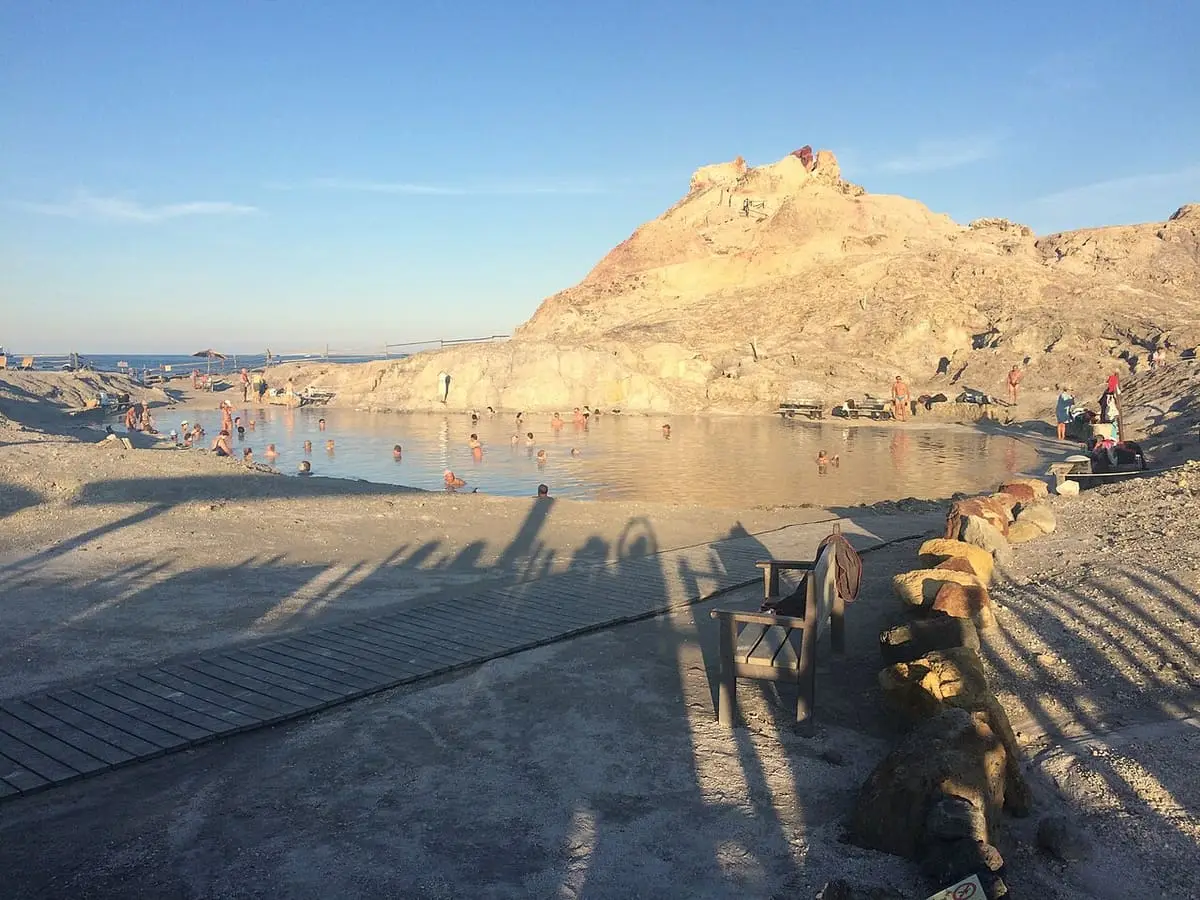 Pozza dei Fanghi mud pool below the yellow rock of the Faraglione on Vulcano in evening light
