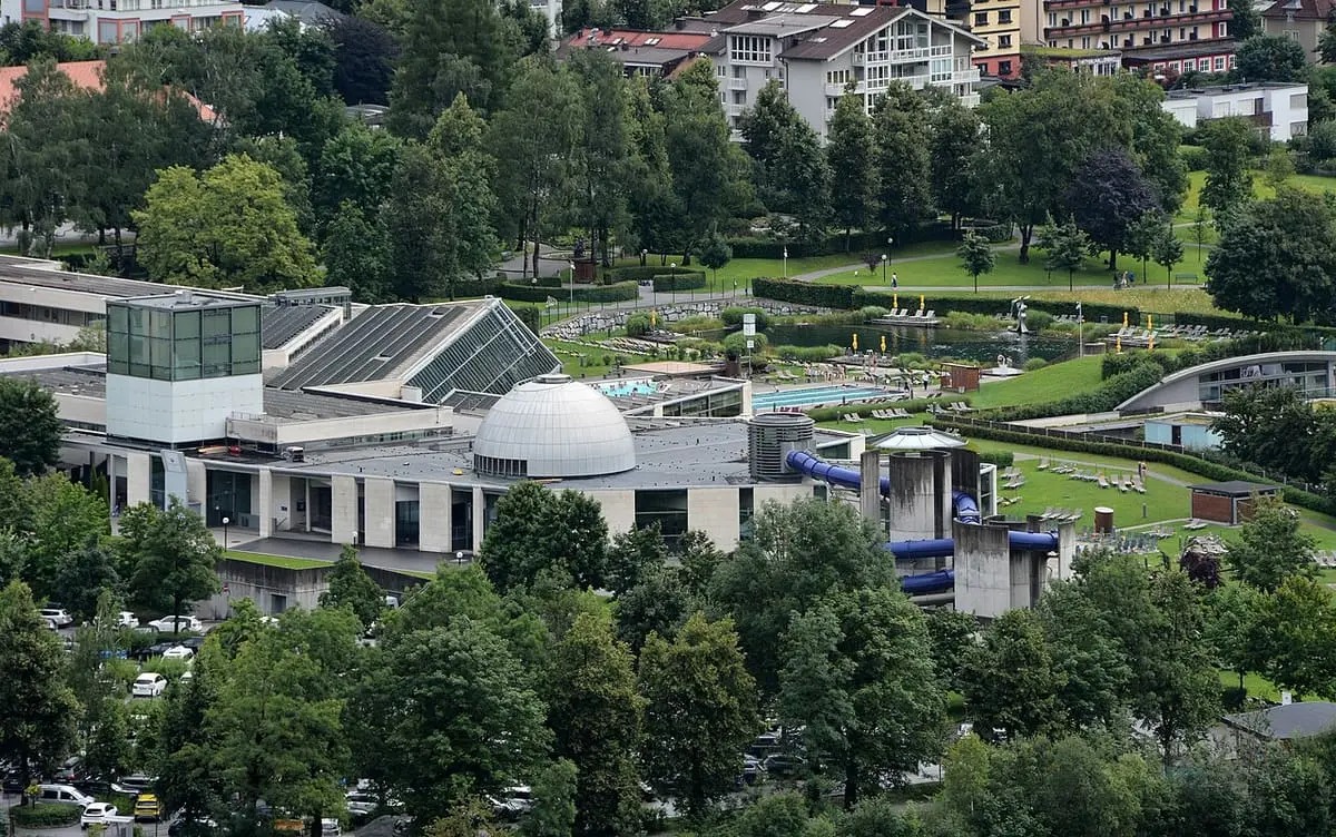Alpentherme Gastein seen from above with its dome, outdoor pools, slides and thermal lake