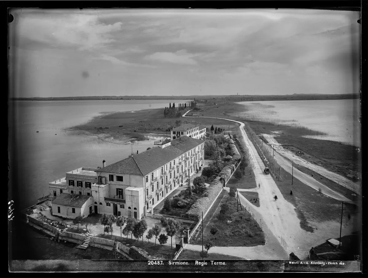 Historic black and white view over the Sirmione peninsula and the Terme di Sirmione hotel on Lake Garda