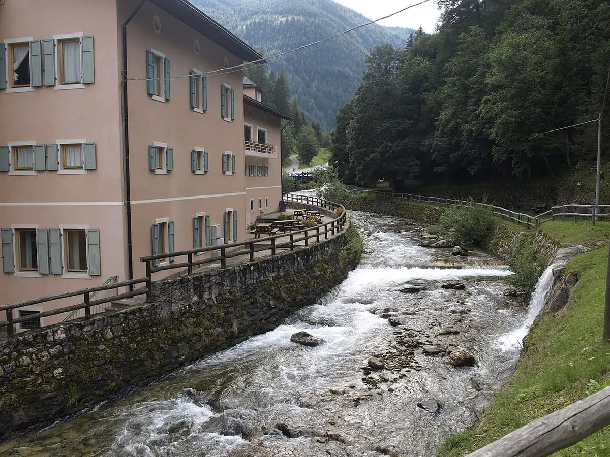 Terme di Rabbi building along the walled bank of a rocky alpine stream in Val di Rabbi