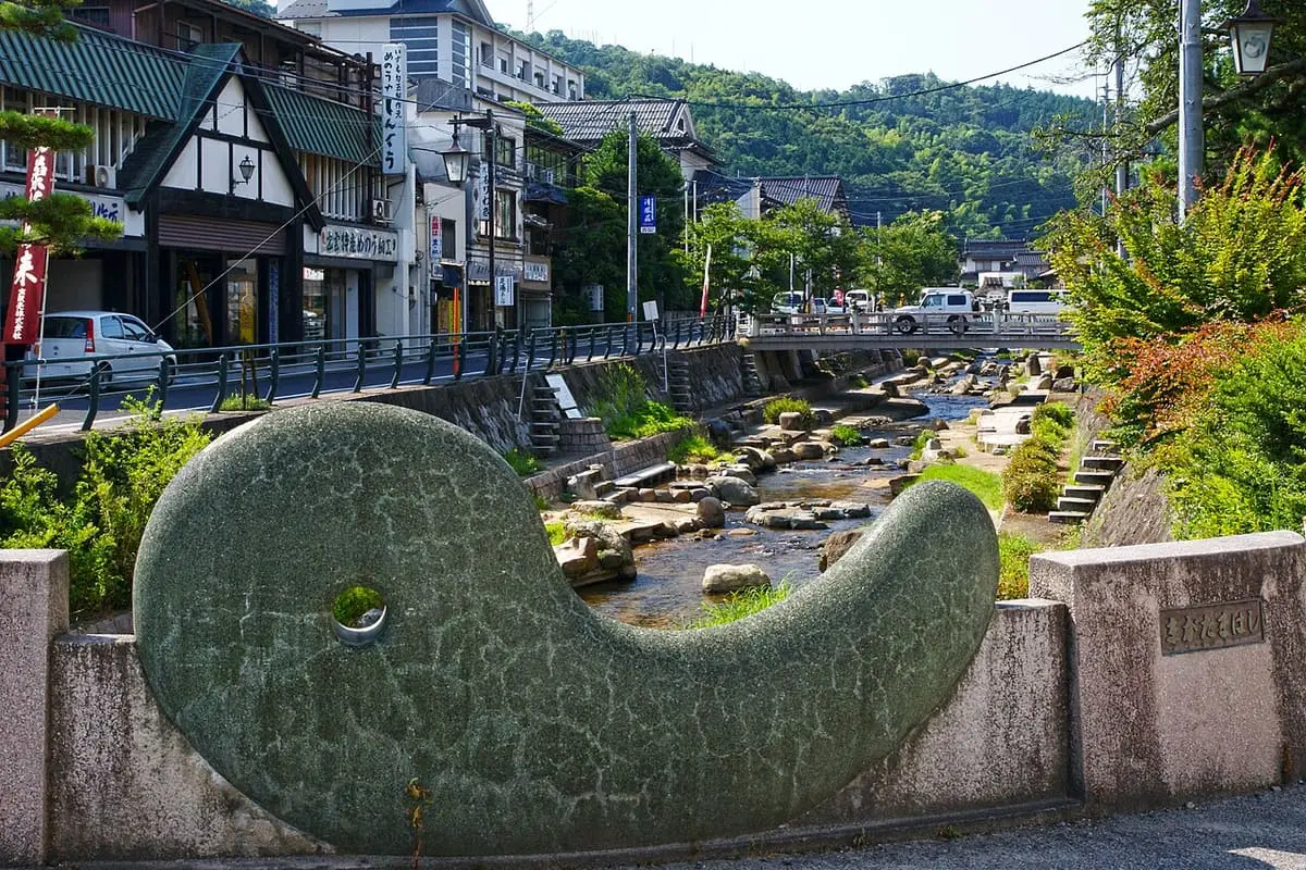 Magatama stone sculpture beside the river running through Tamatsukuri Onsen town