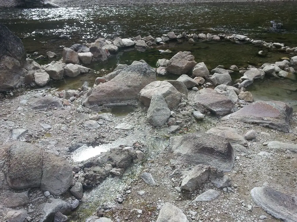 Ring of rocks forming soaking pools at the edge of the South Fork Payette River at Sacajawea Hot Springs