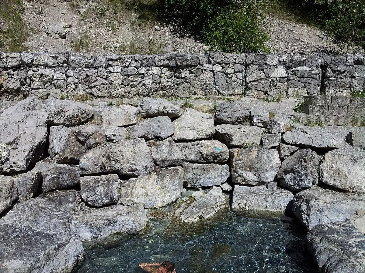 Stacked stone walls around a pool at Lussier Hot Springs