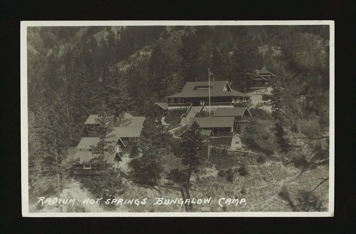 Historic postcard of the Radium Hot Springs bungalow camp among pine trees