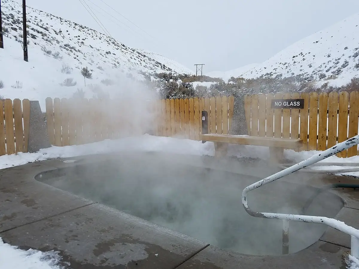 Steam rising from a concrete hot spring pool in winter at Sharkey Hot Springs