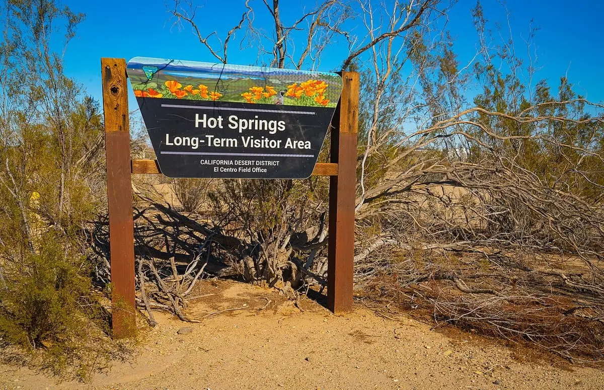 Hot Springs Long Term Visitor Area entrance sign among dry desert shrubs