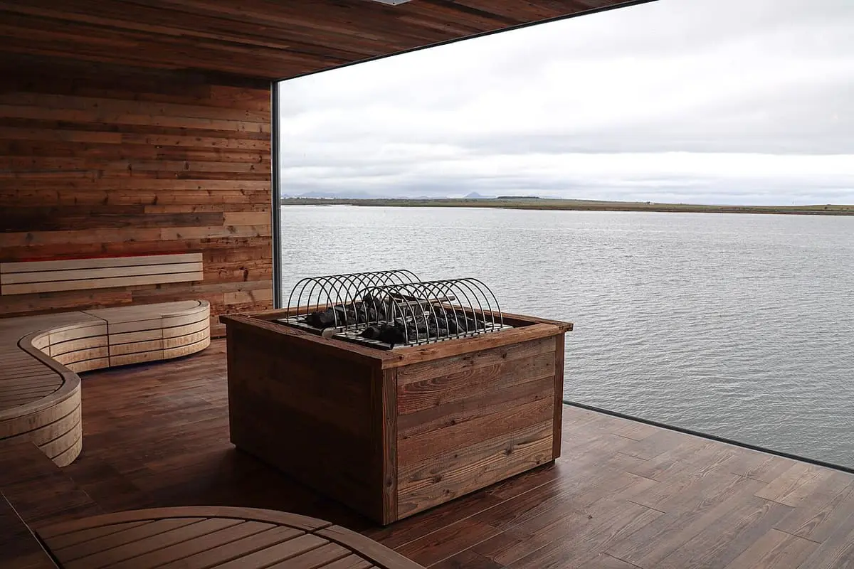 Sky Lagoon sauna with wooden benches and a large window over the sea
