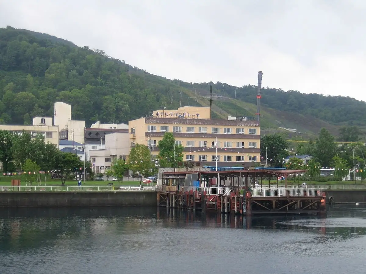 Lakeside hotels of Toyako Onsen reflected in the calm water of Lake Toya