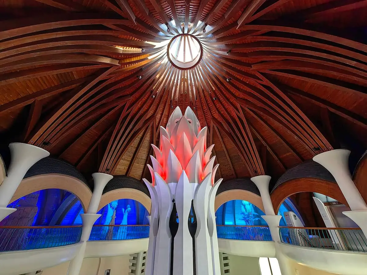 Ribbed timber dome and sculpted white columns above the pools of Hagymatikum