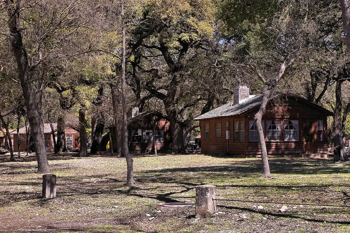 Historic wooden overnight cabin among oak trees at Garner State Park