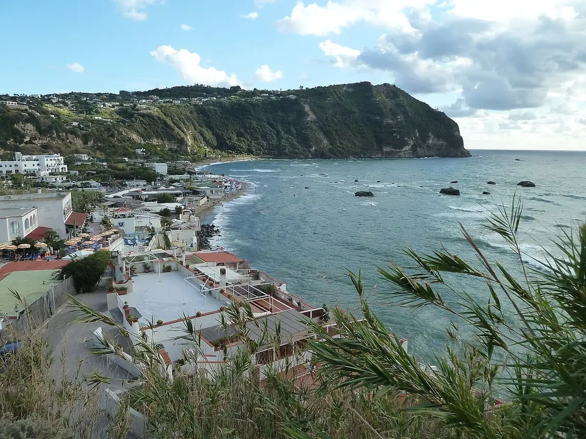Citara bay below the green headland of Punta Imperatore on the west coast of Ischia