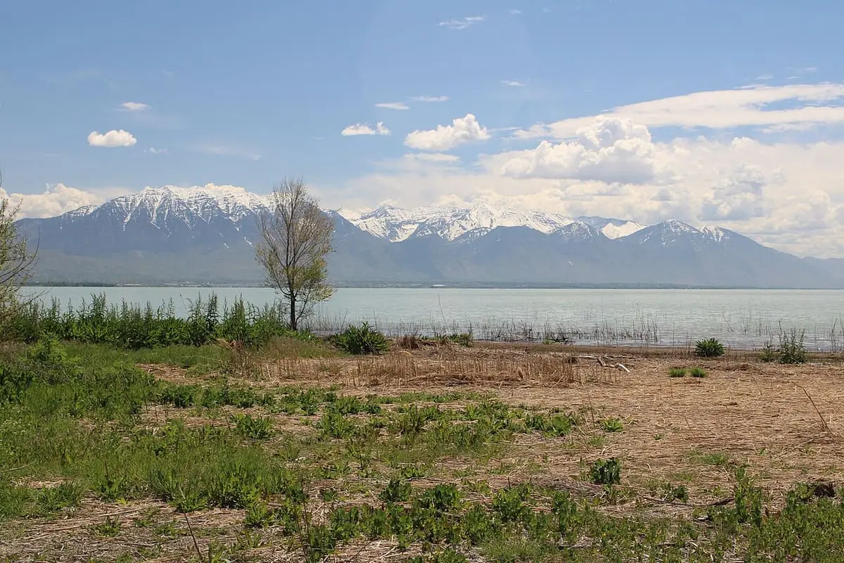 Utah Lake and snow capped Wasatch Mountains seen from the shore at Saratoga Hot Springs