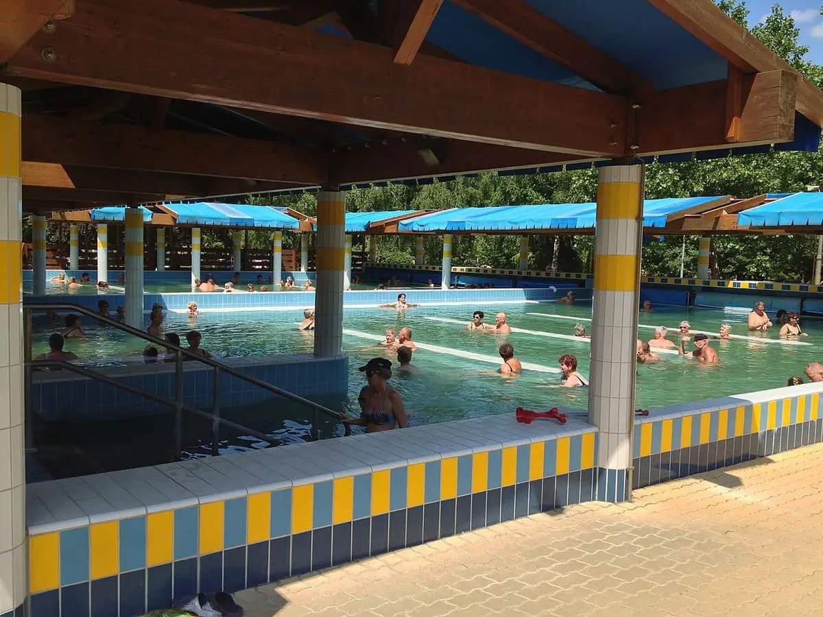 Covered thermal pool with yellow and blue tiled edges at the Zalakaros bath