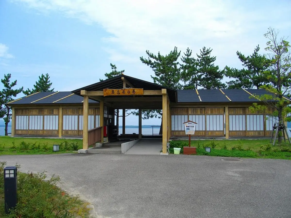 Wooden foot bath pavilion of Tsumagoi Fune no Yu at Wakura Onsen by the bay