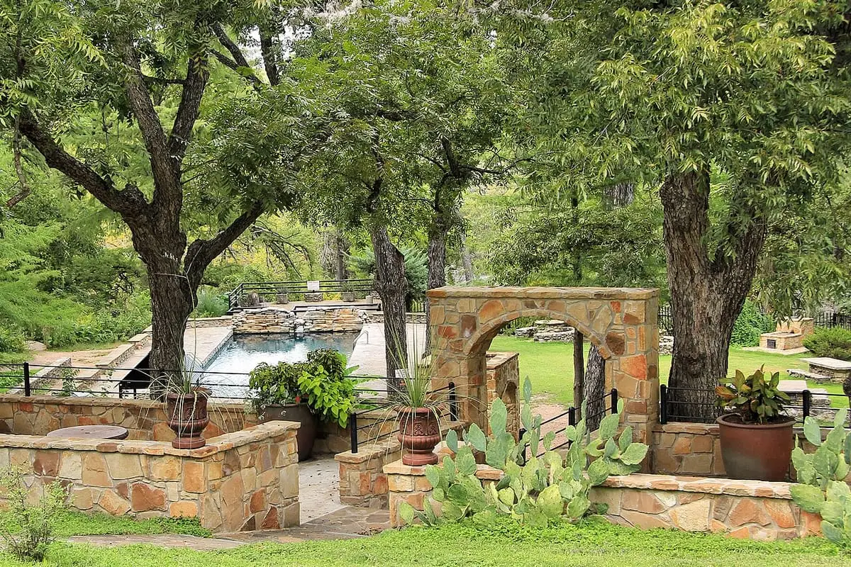 Stone walled garden around the man made swimming pool at Krause Springs