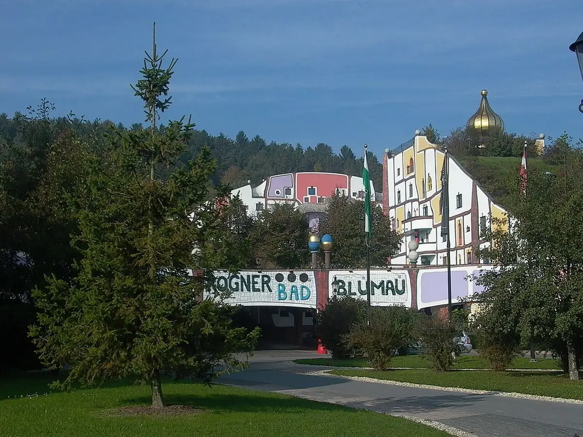 Entrance road and Rogner Bad Blumau sign in front of the colorful Hundertwasser spa buildings