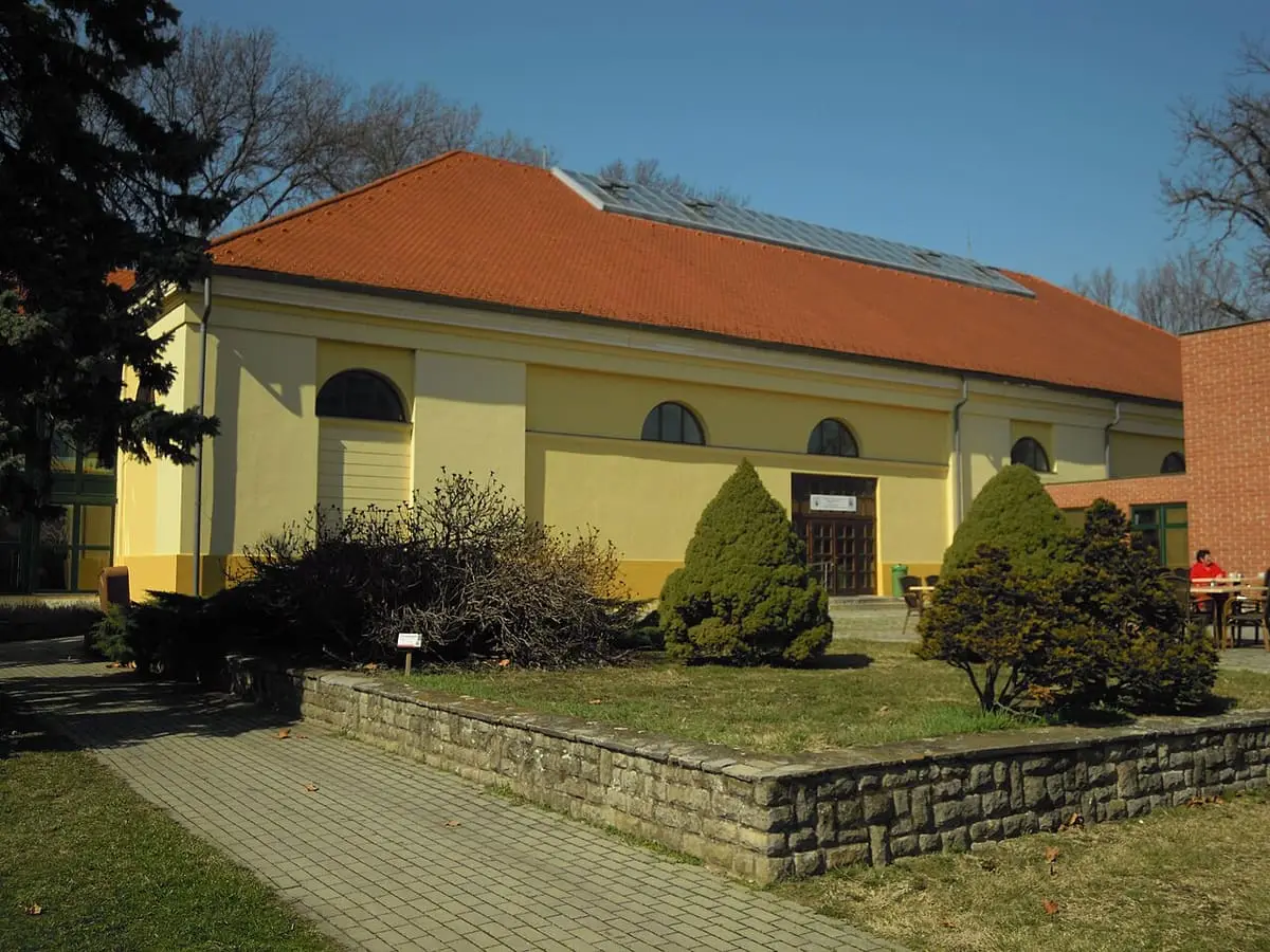 Yellow side facade of the old riding hall, now part of Gyula Castle Bath