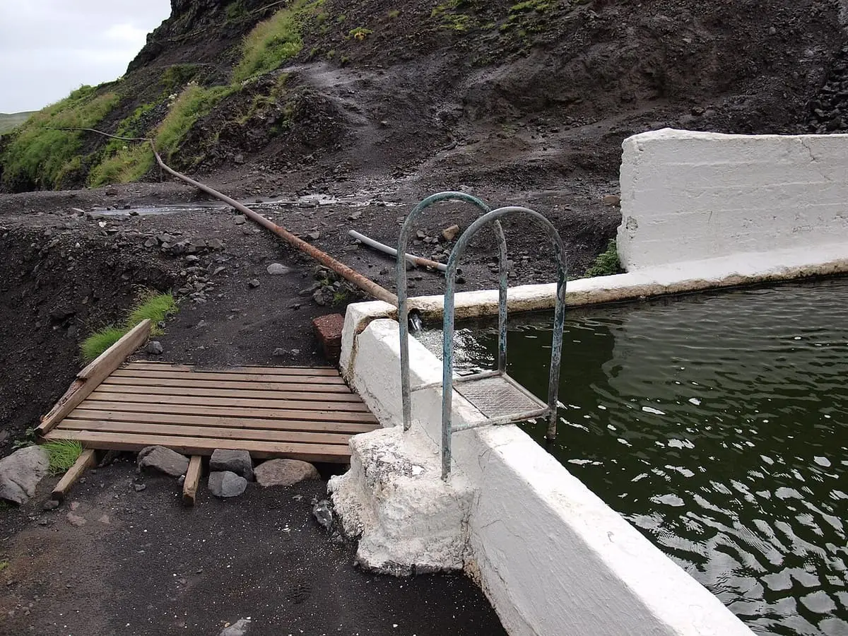 Hot water pipe and metal ladder at the corner of the Seljavallalaug pool