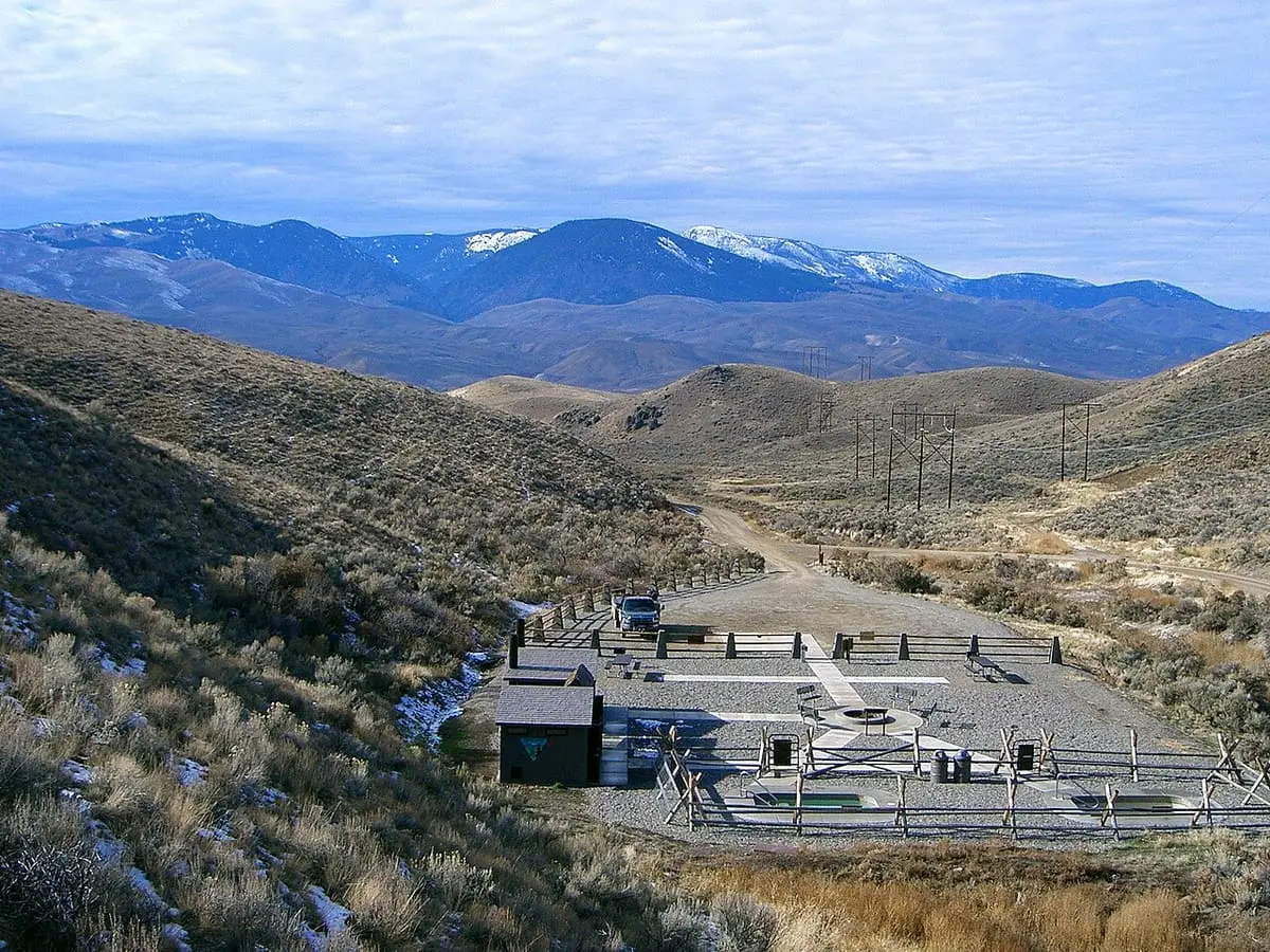 Sharkey Hot Springs site in a sagebrush valley with snow capped mountains beyond