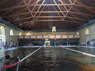 Indoor pool under the timber roof of the former riding hall at Gyula Castle Bath