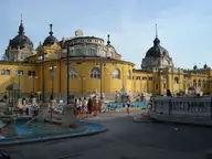 Yellow neo baroque domes of the Széchenyi Thermal Bath around its outdoor pool courtyard