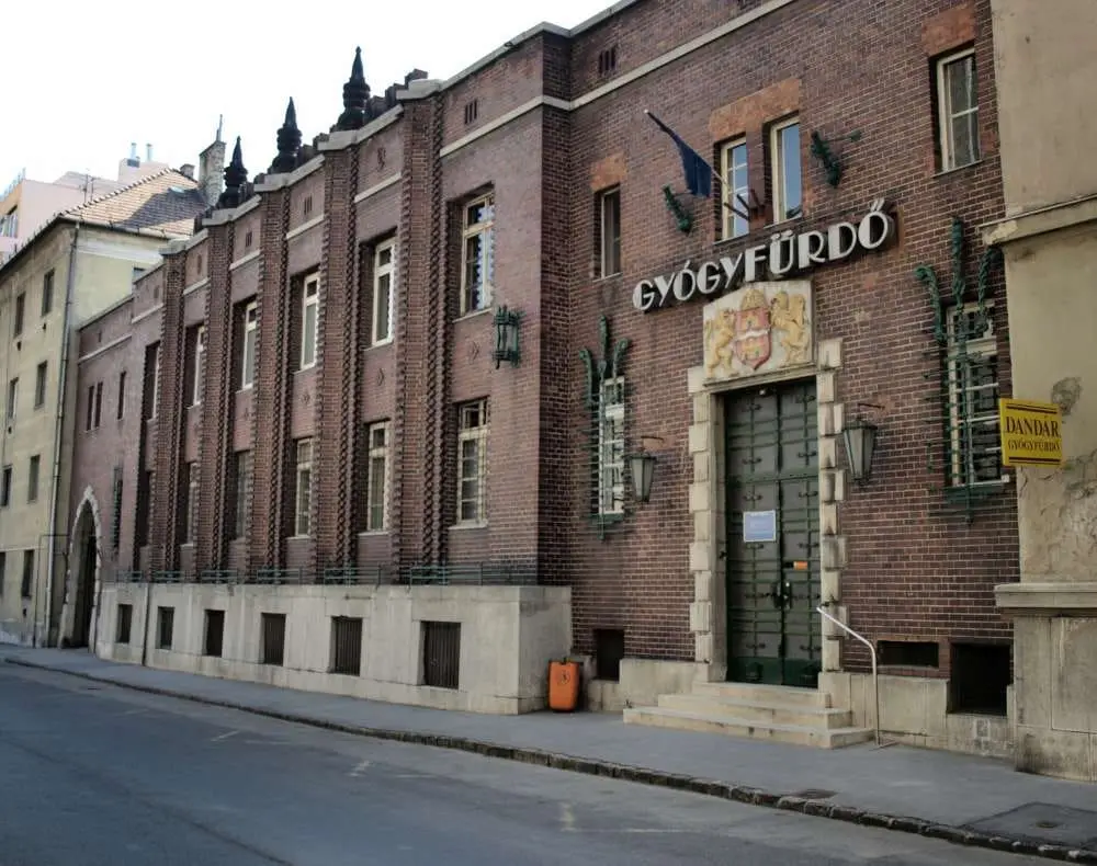 Red brick 1930 facade of the Dandár Thermal Bath with its Gyógyfürdő sign in Budapest