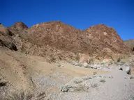 Gravel desert wash below rugged red volcanic hills in the Black Mountains near Arizona Hot Springs