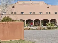 Arched stucco facade and walled courtyard of Sierra Grande Lodge in Truth or Consequences