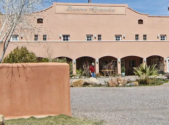 Arched stucco facade and walled courtyard of Sierra Grande Lodge in Truth or Consequences