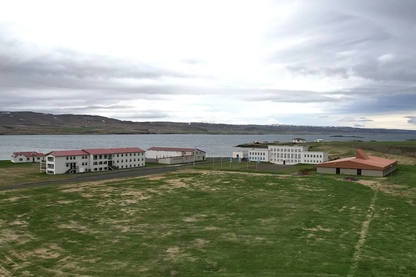 Reykjaskóli school buildings at Reykir on the shore of Hrútafjörður under a cloudy sky