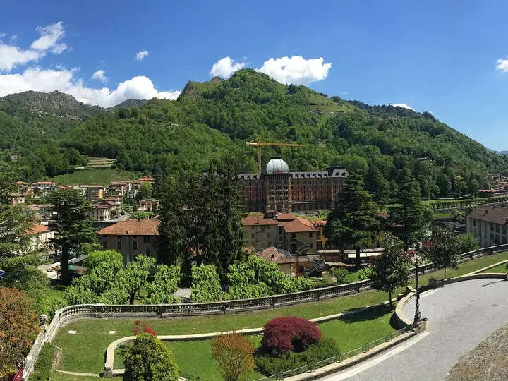 San Pellegrino Terme spread along a green valley, with the domed Grand Hotel among trees