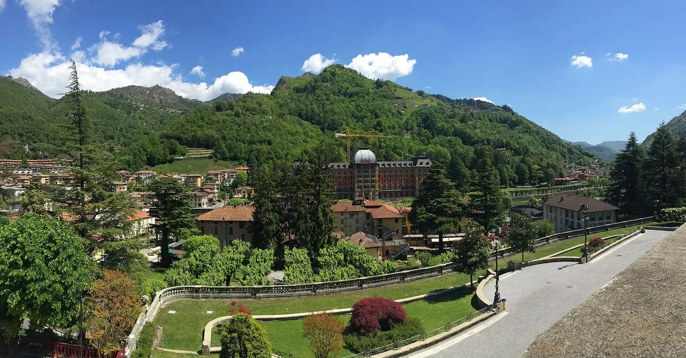 San Pellegrino Terme spread along a green valley, with the domed Grand Hotel among trees