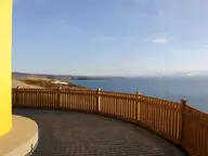 View from the yellow lighthouse on the Húsavík headland across Skjálfandi Bay to snowy mountains