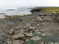 Panorama of the rock edged Hellulaug hot pot on the shore of Vatnsfjörður