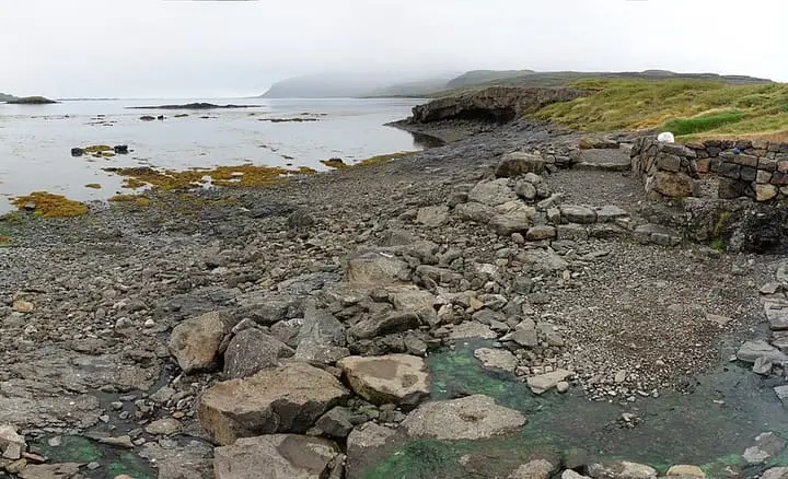 Panorama of the rock edged Hellulaug hot pot on the shore of Vatnsfjörður