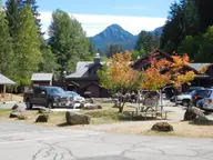 Sol Duc Hot Springs Resort lodge among evergreens and autumn maples below a forested peak