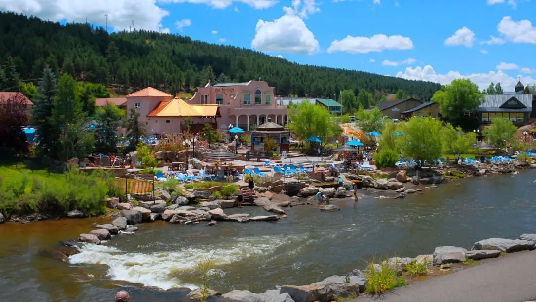 The Springs Resort soaking pools and pink buildings along the San Juan River in Pagosa Springs