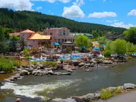 The Springs Resort soaking pools and pink buildings along the San Juan River in Pagosa Springs