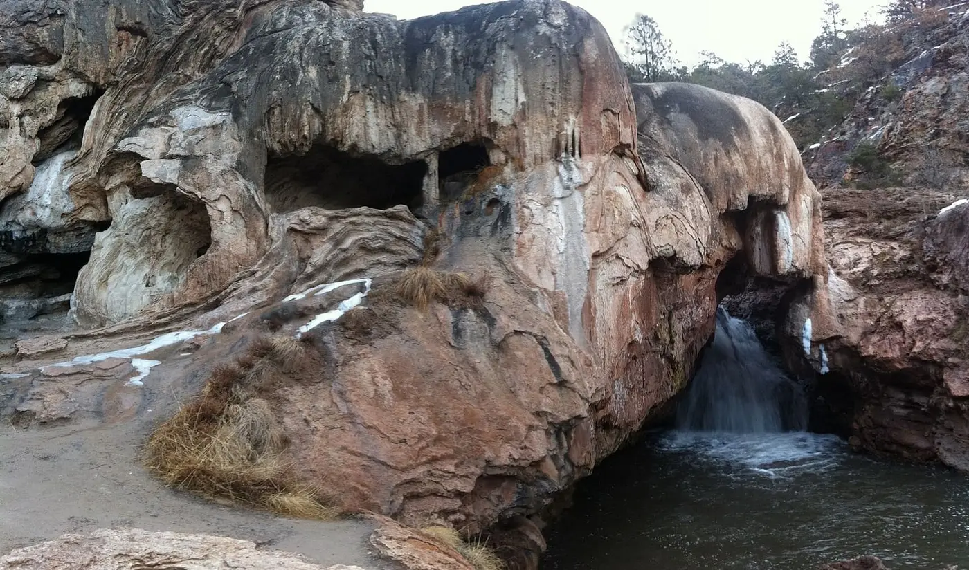 Soda Dam travertine formation with the Jemez River pouring through a gap into a pool