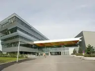 Modern angular glass facade and entrance canopy of Therme Wien in Oberlaa, Vienna