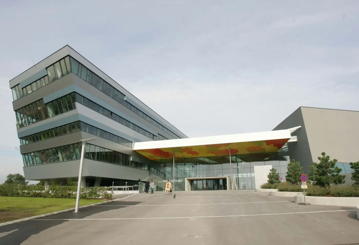 Modern angular glass facade and entrance canopy of Therme Wien in Oberlaa, Vienna