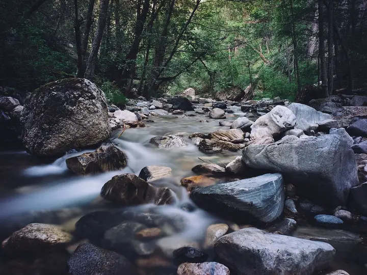 Big Sur River tumbling over mossy boulders in the forest near Sykes Hot Springs