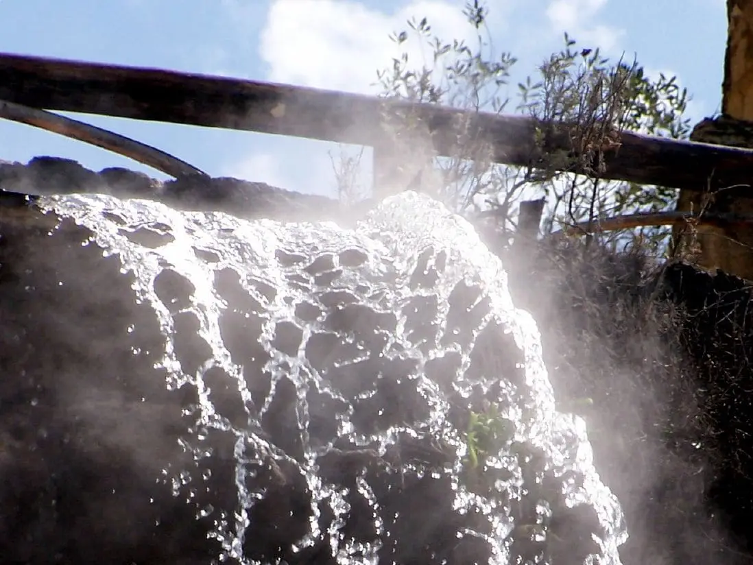 Steaming hot water cascading down a rock wall at Giardini Poseidon Terme on Ischia