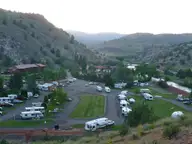 Kah Nee Ta Hot Springs Resort and campground with RVs on green lawns in a dry canyon valley